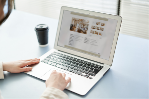 Person looking at a real estate blog page on a laptop.